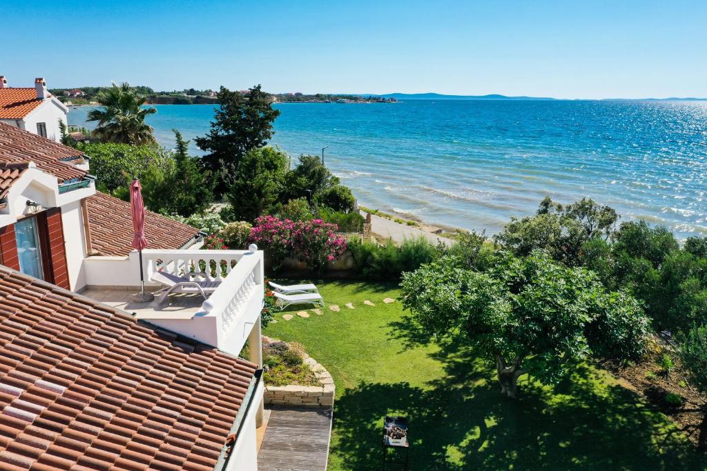 a view of the ocean from the balcony of a house at Bed&Breakfast Vanni in Privlaka