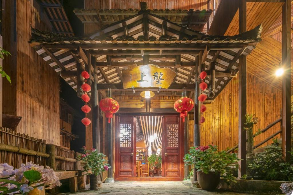 an entrance to a building with a wooden door at Ridge Inn in Longsheng