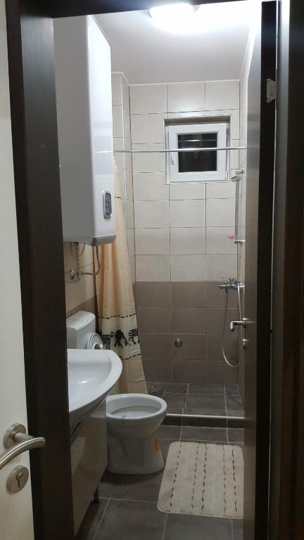 a small bathroom with a toilet and a sink at Studio apartman - Centar in Tivat