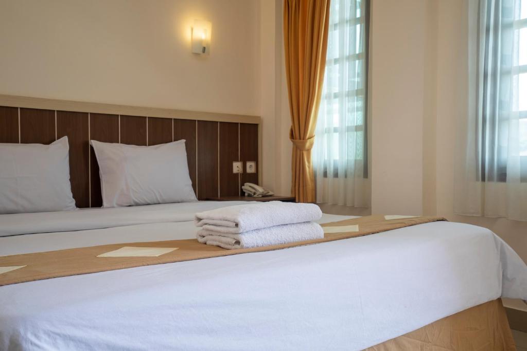 Postel nebo postele na pokoji v ubytování Dago's Hill Hotel