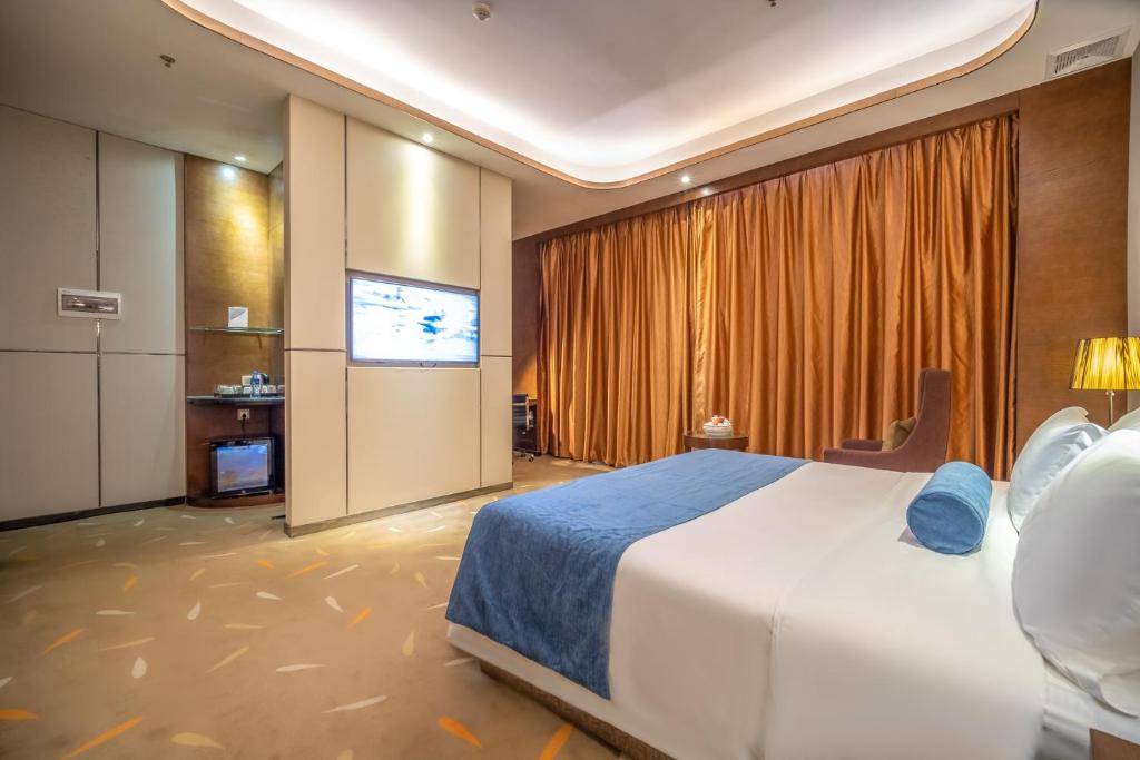 Postel nebo postele na pokoji v ubytování Relteem Hotel