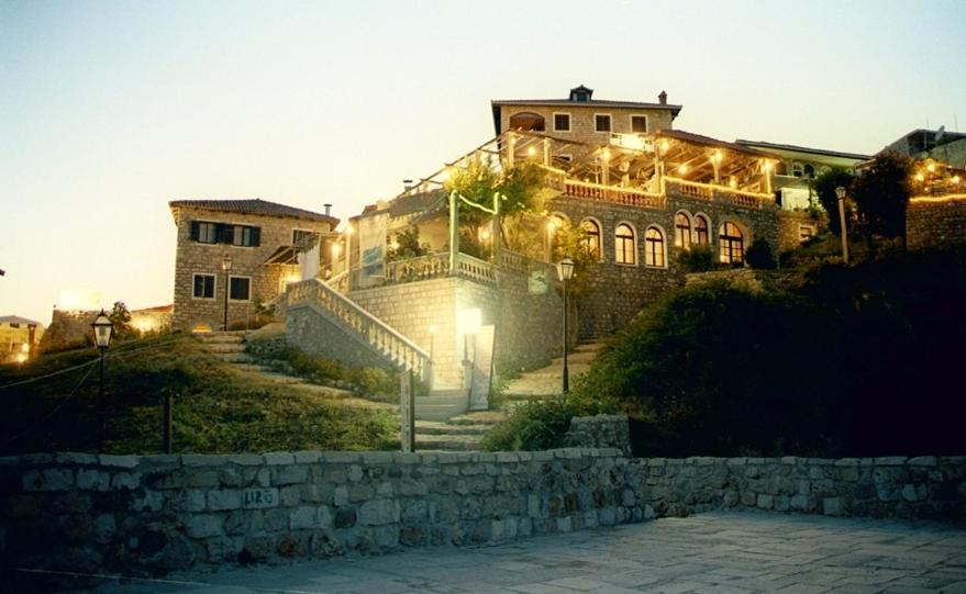 a large building with lights on the side of it at Apartments Kalaja in Ulcinj