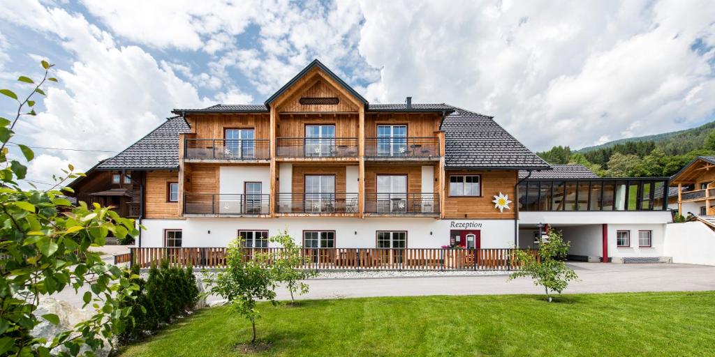 ein großes Holzhaus mit großem Hof in der Unterkunft Feriendorf Edelweiss in Mariapfarr