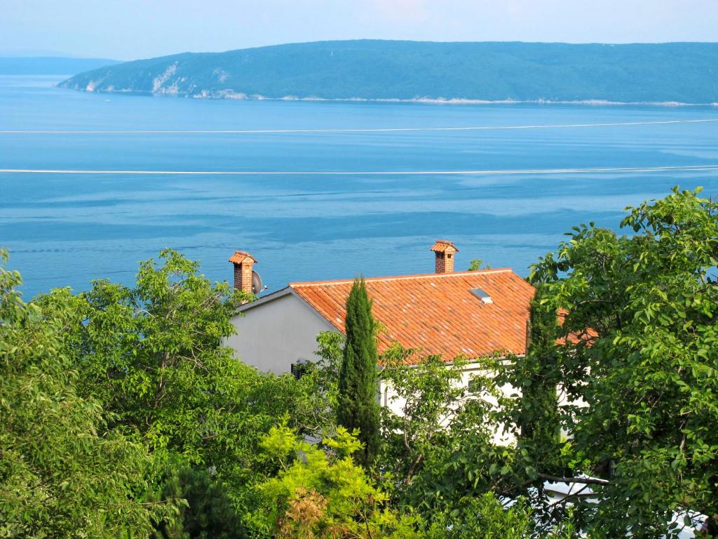 a house with a red roof overlooking the water at Apartment Branka-1 by Interhome in Mošćenice