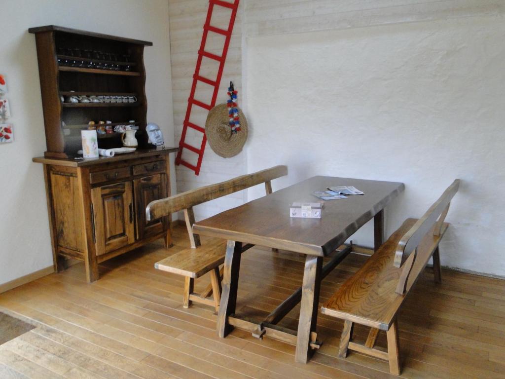 a dining room with a wooden table and chairs at Ty Clara in Landéda