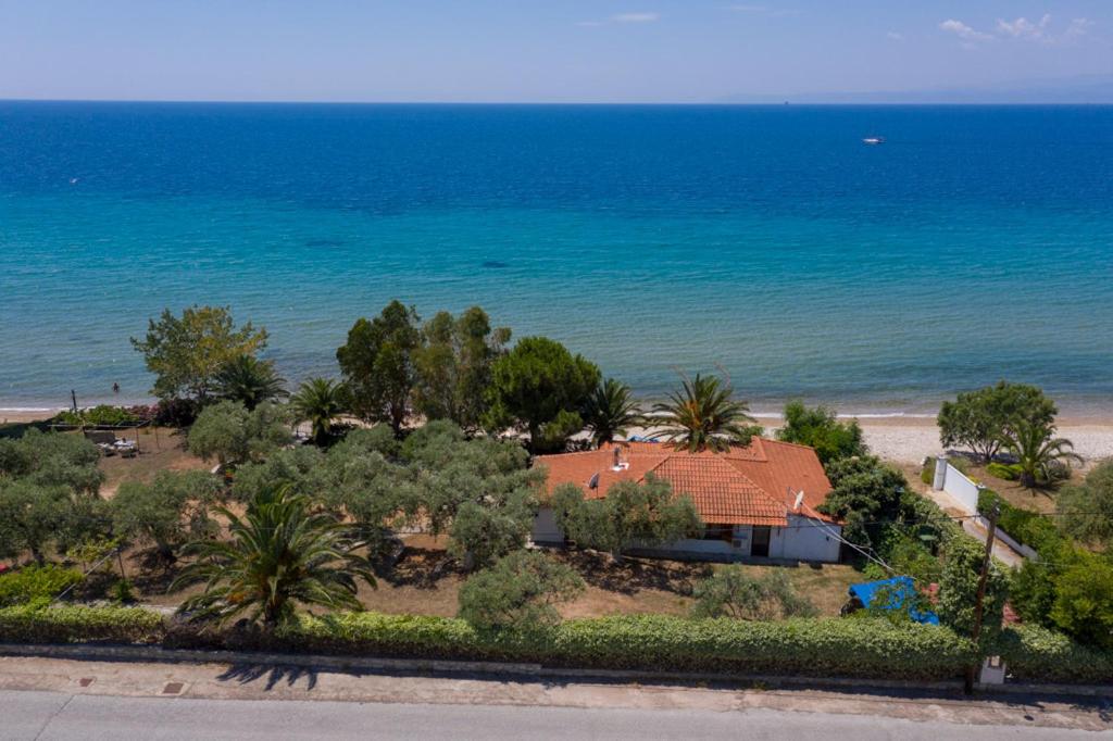 a house on the beach next to the ocean at Front Beach House in Skala Kallirachis