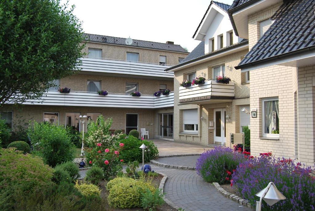 a house with a garden of flowers in front of it at Pension Wortmann in Bad Laer