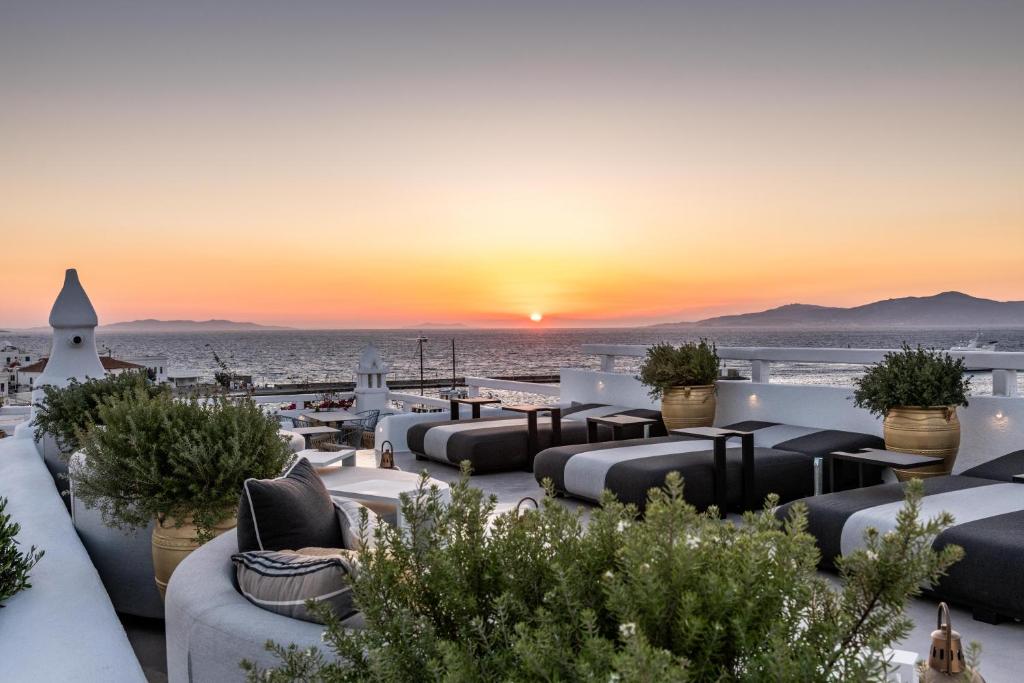 a view of the sunset from the rooftop of a hotel at The TownHouse Mykonos in Mýkonos City