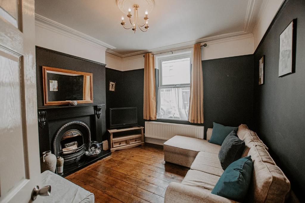 a living room with a couch and a tv at No 7 Gray Street in Lincoln