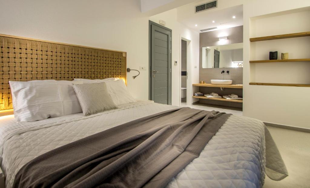 Postel nebo postele na pokoji v ubytování Oro Suites
