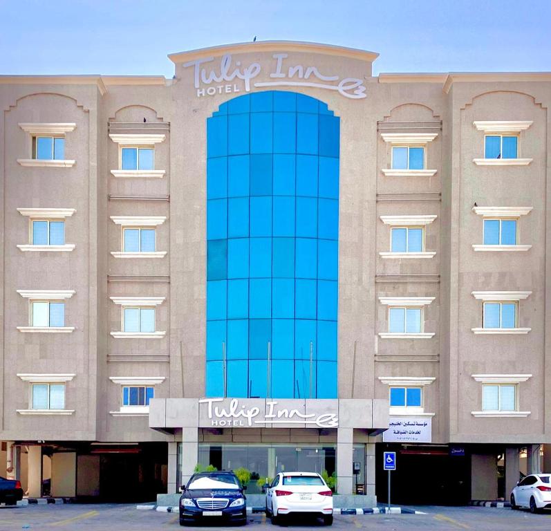 un hotel con coches aparcados delante en Tulip Inn Corniche Dammam, en Dammam