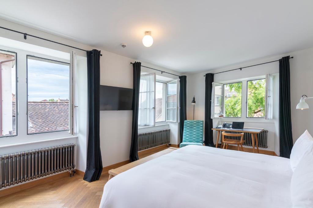 a hotel room with a bed and a window at Marktgasse Hotel in Zurich