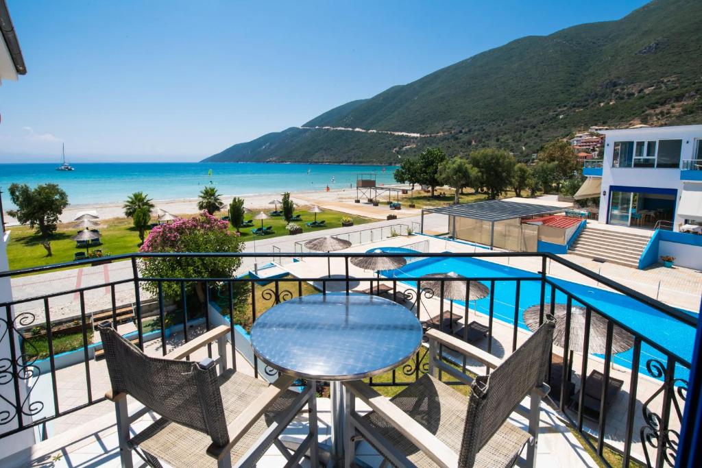 a balcony with a table and a view of the beach at Surf Hotel in Vasiliki