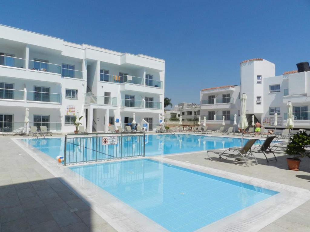a swimming pool in front of a building at Evabelle Napa Hotel Apartments in Ayia Napa