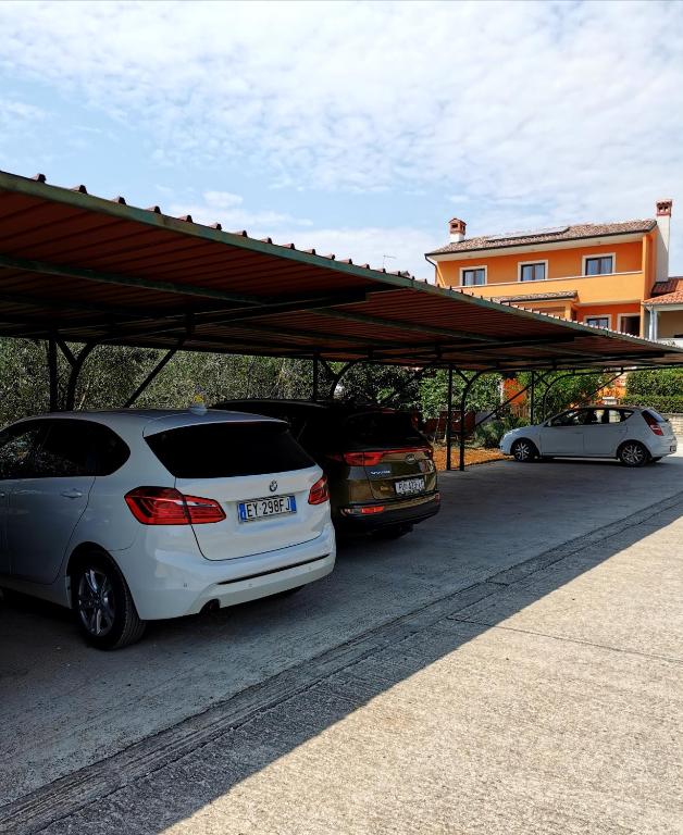 two cars parked in a parking lot next to a building at Villa Lamanova in Rovinj