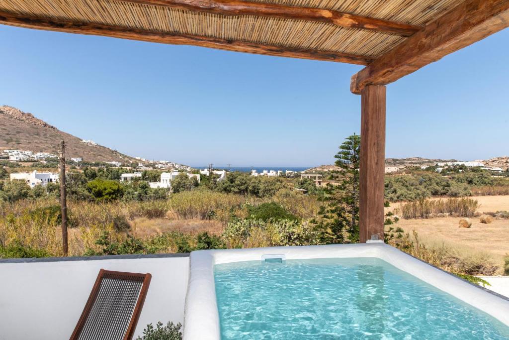 a view of a swimming pool from the balcony of a house at Thea Suites Naxos in Agios Prokopios