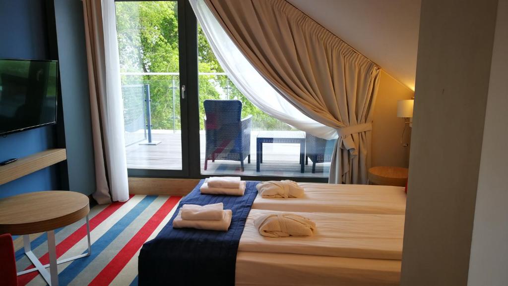 Postel nebo postele na pokoji v ubytování Hotel Skipper