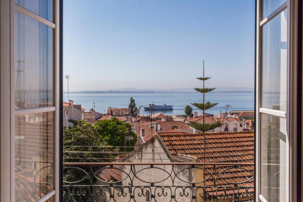 a view of a city from a window at Amazing river view in historical Lisbon in Lisbon