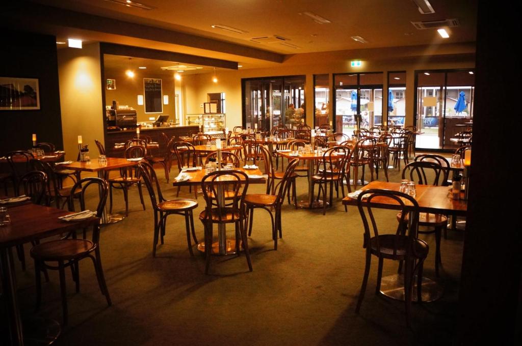 
a restaurant with tables and chairs in it at Spinifex Hotel in Derby
