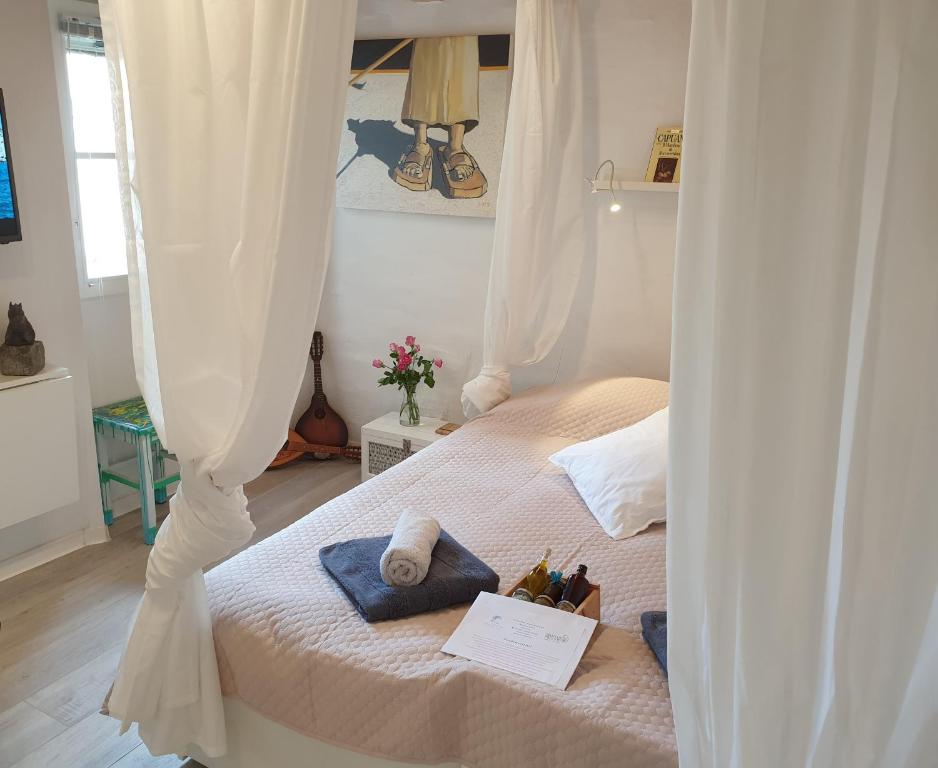 a bedroom with two beds with white curtains at PiranArt Guest house in Piran