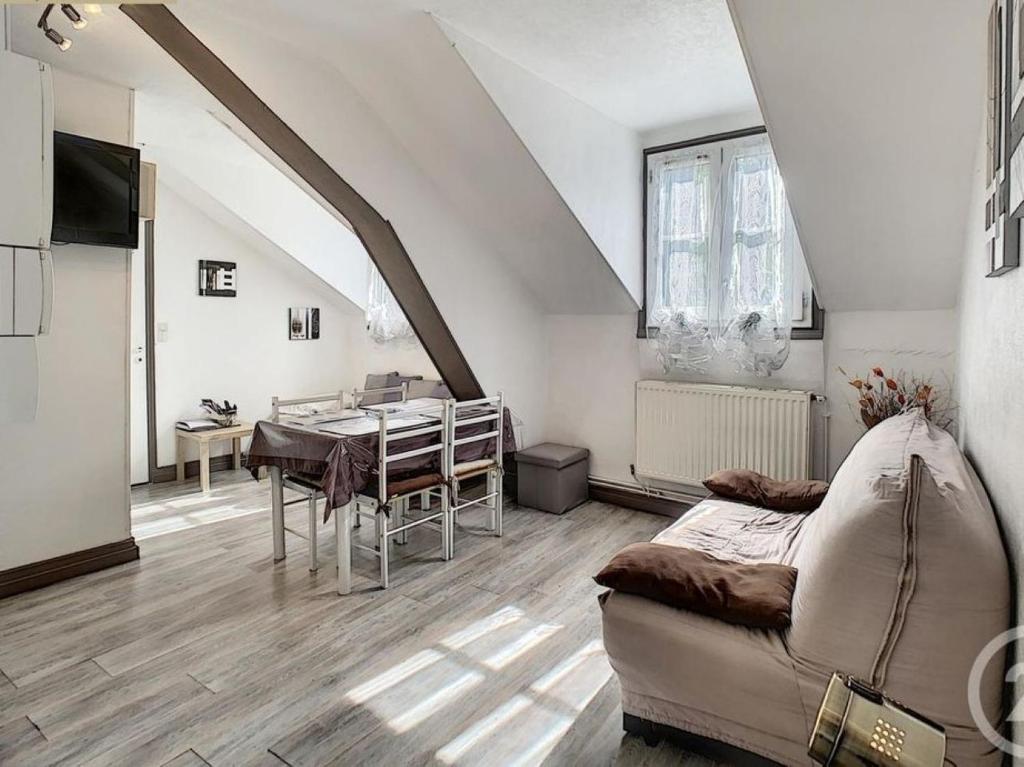 a living room with a couch and a dining room table at Résidence du Baliran in Luchon