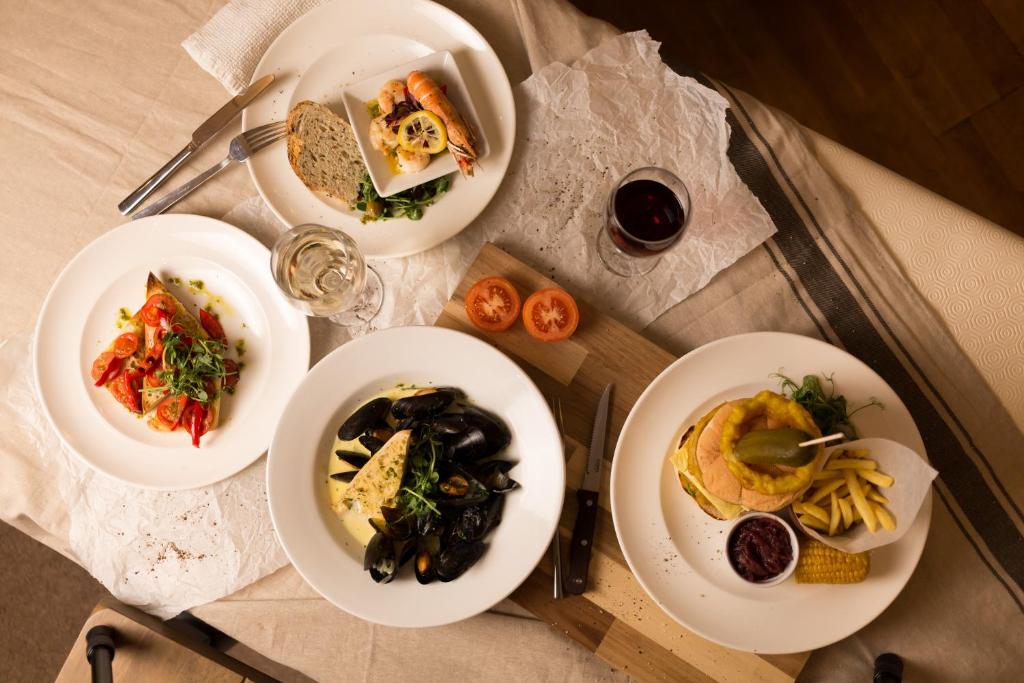 a table with four plates of food on it at Warkworth House Hotel in Warkworth