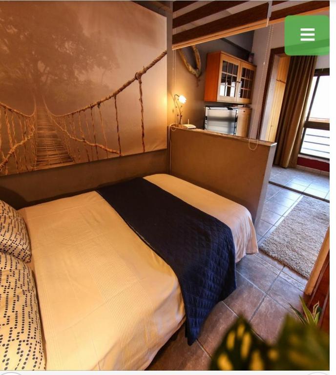 a bedroom with two beds in a room with a hammock mural at Aparta o aporta in Salou
