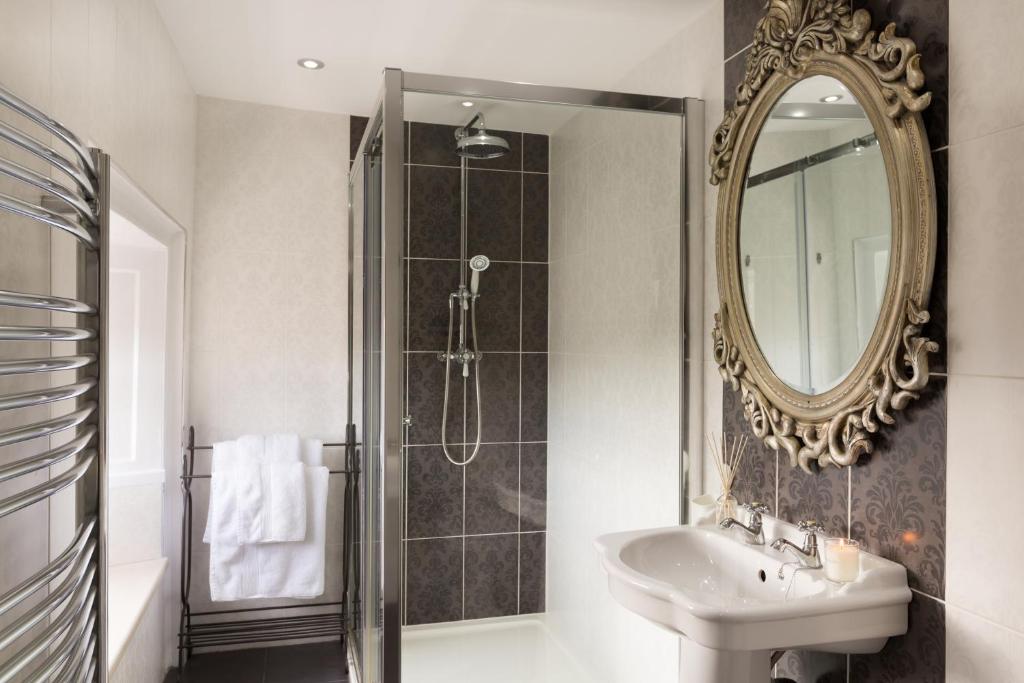 a bathroom with a sink and a mirror at Warkworth House Hotel in Warkworth