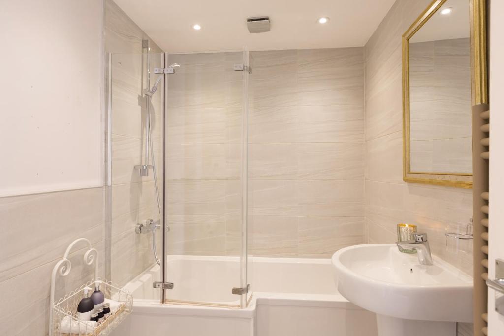 a bathroom with a tub and a sink and a shower at Warkworth House Hotel in Warkworth