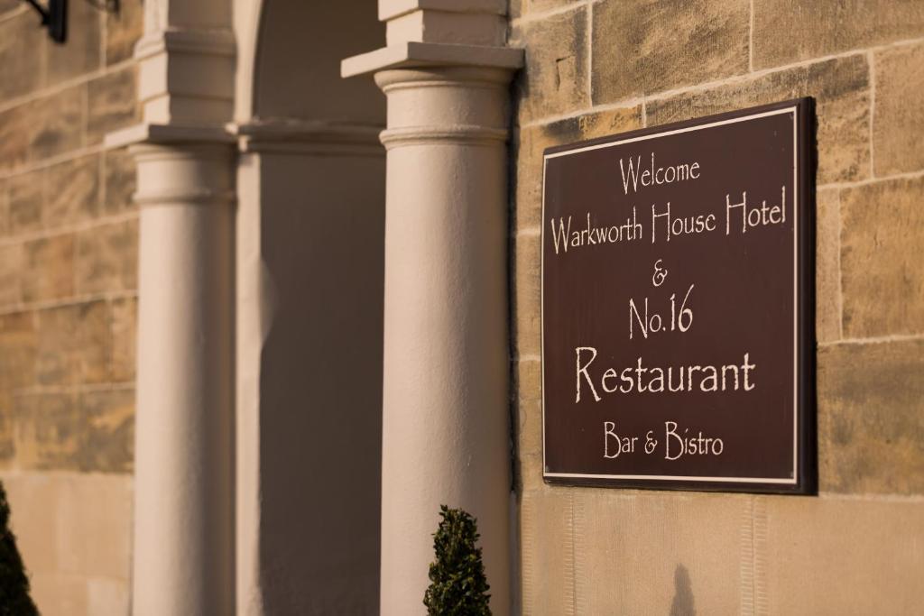 a sign on the side of a building at Warkworth House Hotel in Warkworth