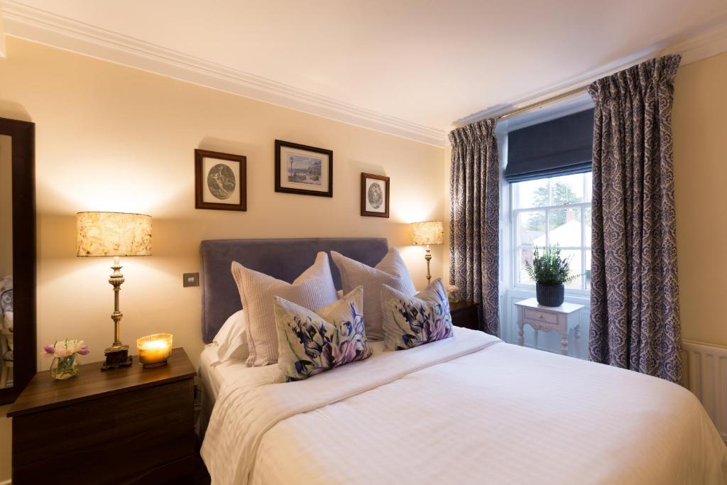 a bedroom with a large bed and a window at Warkworth House Hotel in Warkworth