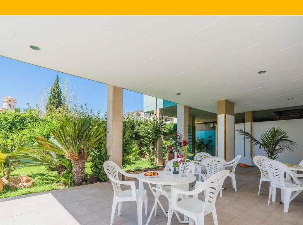 a white table and chairs on a patio at BRESSOL DELUXE Apartments in Port de Pollensa