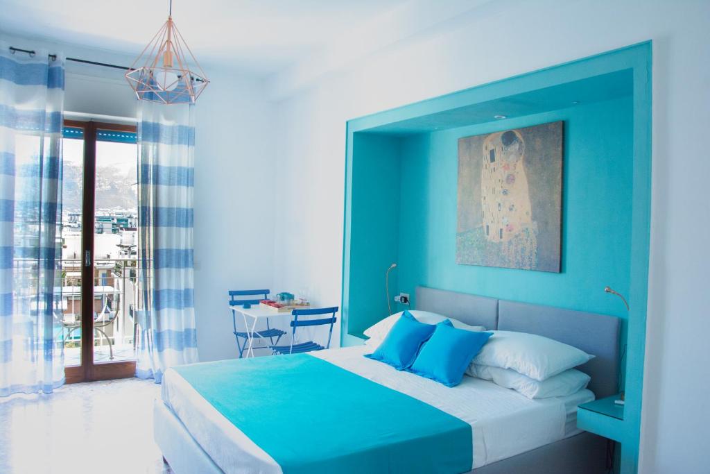 a blue bedroom with a bed and a table at Casa del Corso in Sorrento