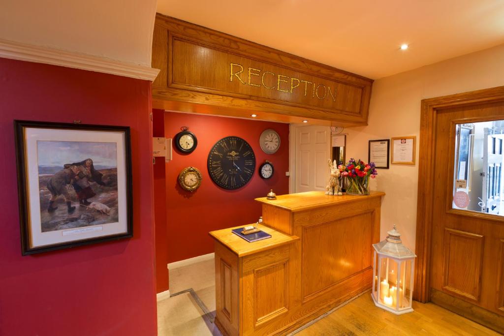 a reputation room with clocks on the wall at Warkworth House Hotel in Warkworth