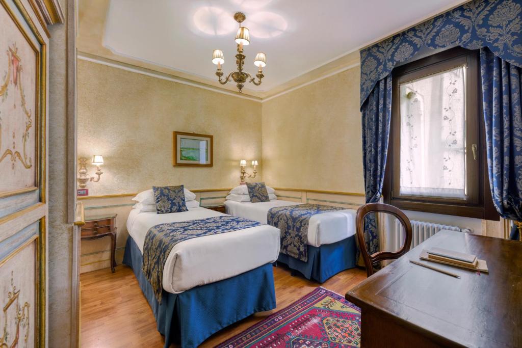 Postel nebo postele na pokoji v ubytování Hotel Al Piave