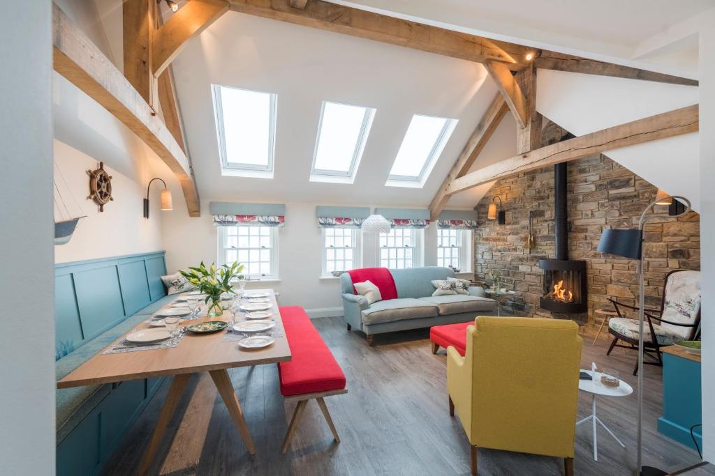 a living room with a table and a couch at Iris 5 Star Gold Award Luxury Cottage in St Ives