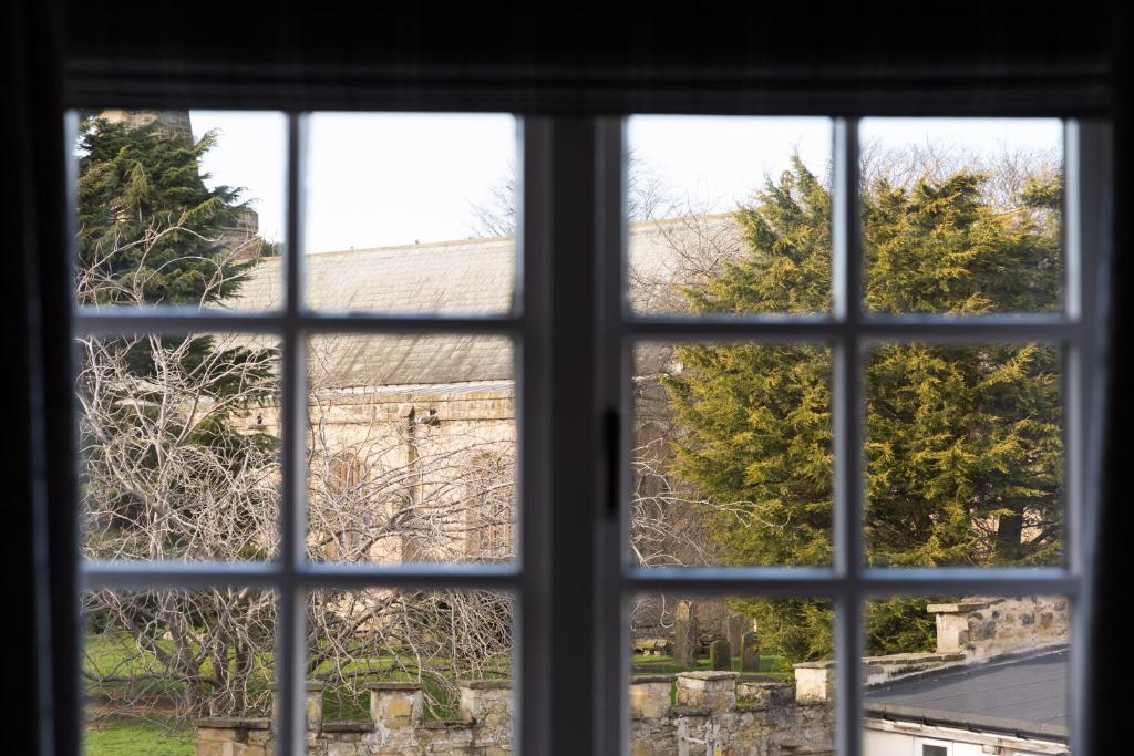 a view through a window of a building at Warkworth House Hotel in Warkworth