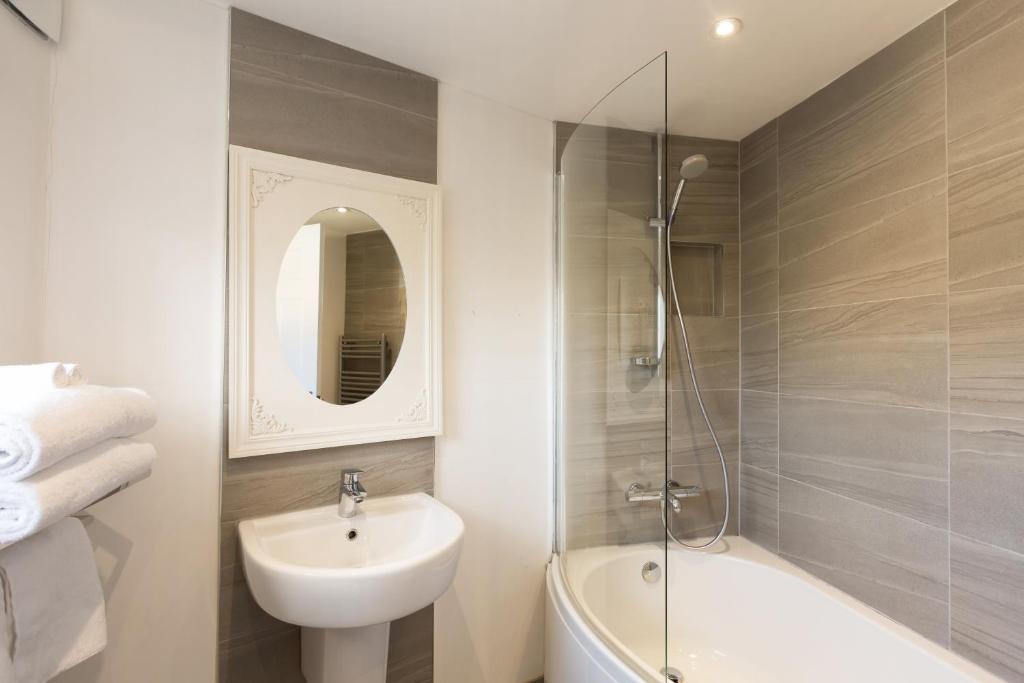 a bathroom with a sink and a toilet and a shower at Warkworth House Hotel in Warkworth