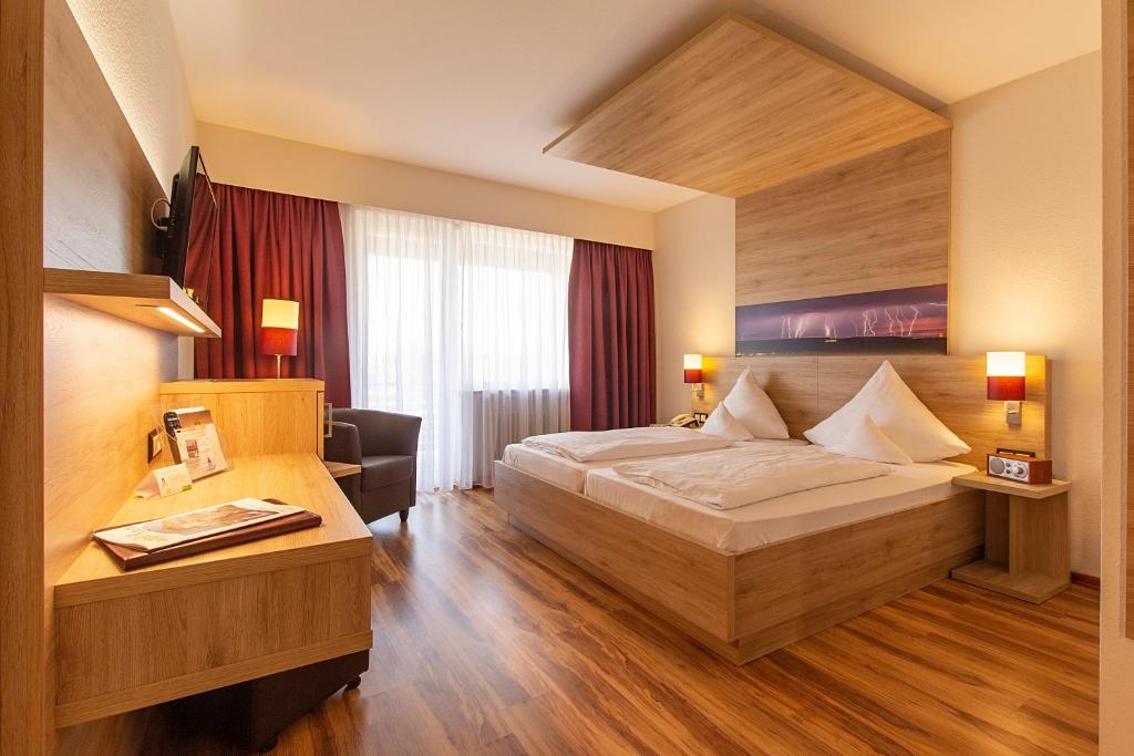 Postel nebo postele na pokoji v ubytování Flair-Hotel Zum Benediktiner