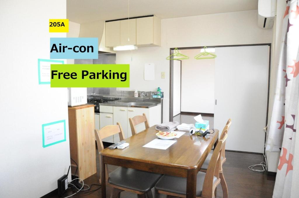a kitchen with a wooden table and chairs in a room at Ark City Asahikawa - Vacation STAY 8526 in Asahikawa