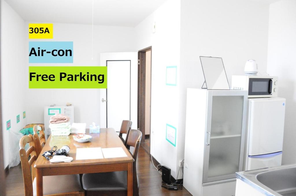 a kitchen with a table and a refrigerator at Ark City Asahikawa - Vacation STAY 8531 in Asahikawa