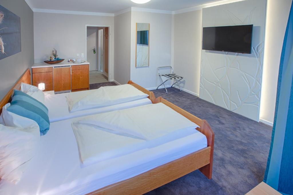 Postel nebo postele na pokoji v ubytování Frühstückshotel Waldbauer