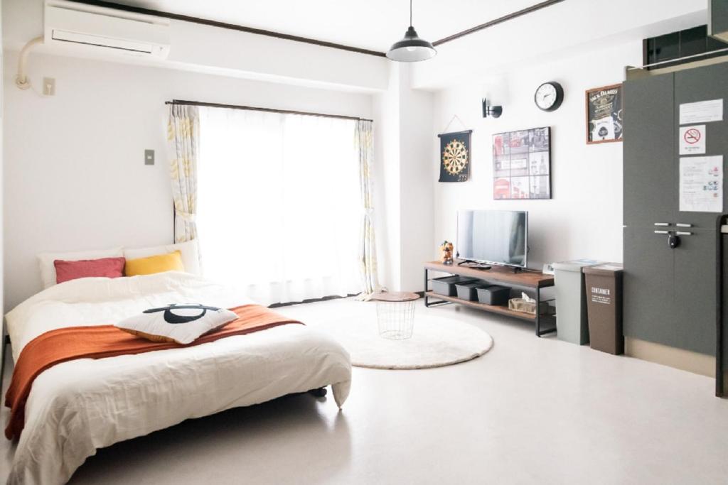 a bedroom with a bed and a large window at Il Sole Kujo - Vacation STAY 8471 in Osaka