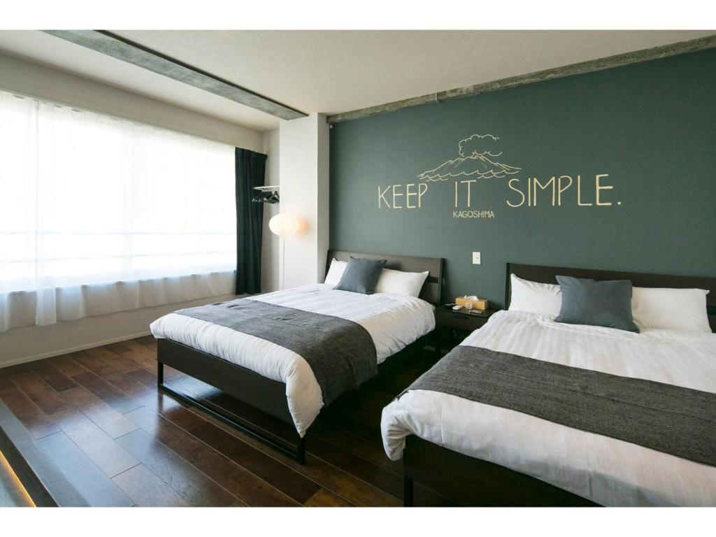 a bedroom with two beds and a sign that says keep it simple at ROI SPACE KAGOSHIMA - Vacation STAY 87818 in Kagoshima