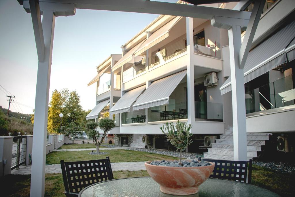 a vase on a table in front of a building at Medusa Luxury Apartments in Néa Péramos