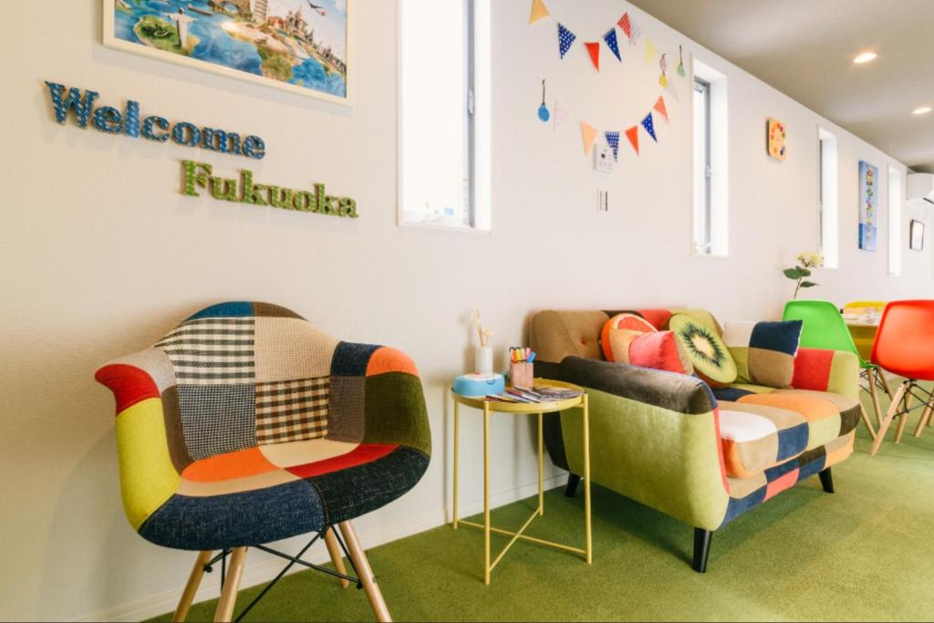 a waiting room with colorful chairs and a table at Room 301 - Vacation STAY 86501 in Fukuoka