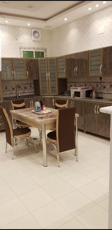 a kitchen with a table and chairs in it at Dar Al Karama Residential Units in AlUla