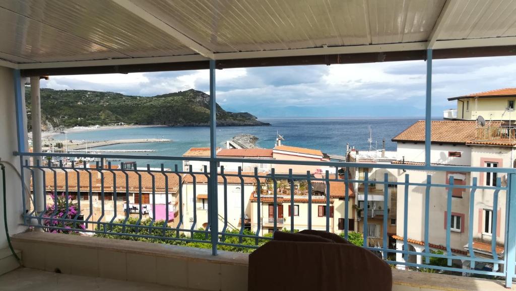a balcony with a view of the ocean and buildings at Casa vacanze Camera con vista in Marina di Camerota