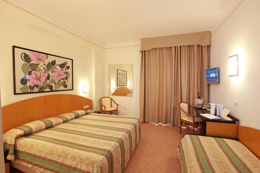 Postel nebo postele na pokoji v ubytování Hotel Caravel