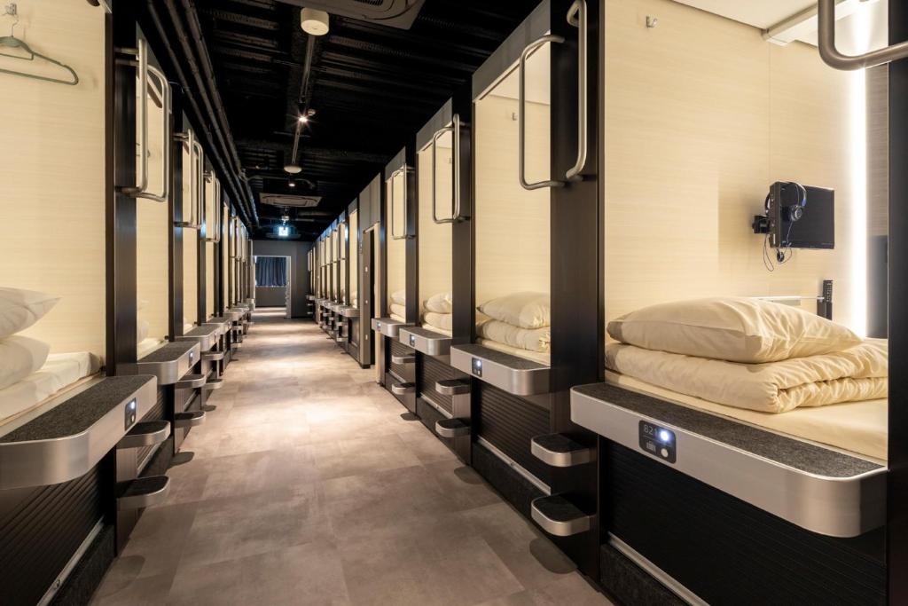 a row of bunk beds in a train at Capsule Hotel Cube Hiroshima in Hiroshima